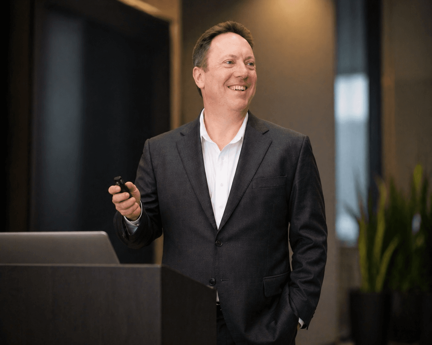 David Taylor presenting on stage with a clicker in hand